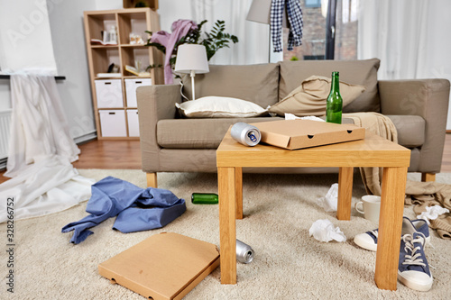 mess, disorder and interior concept - view of messy home living room with scattered stuff