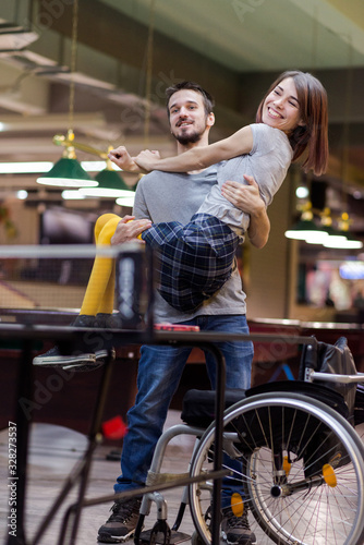 Beautiful disabled girl and her boyfriend celebrating game victory