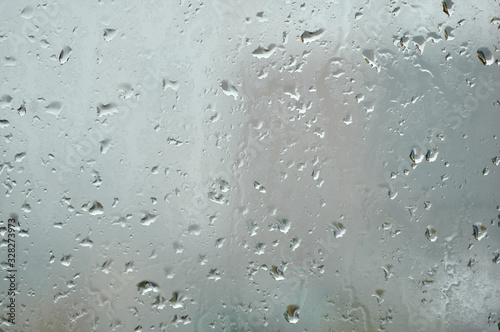 The view from the window through the misted window. Raindrops.
