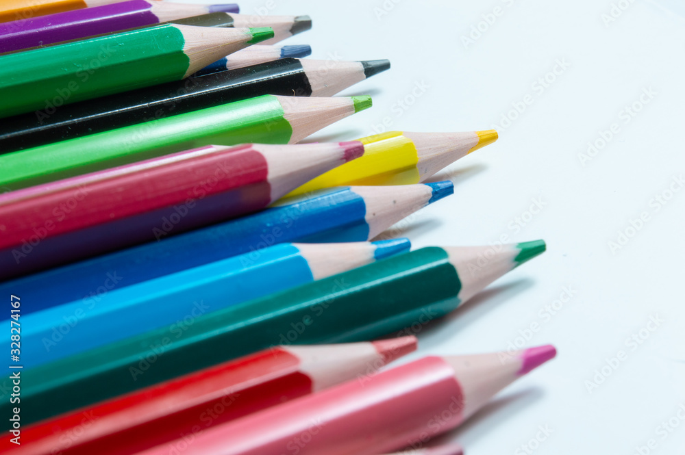 Close-Up Of Multi Colored Pencils Over White Background Close-Up Of Multi Colored Pencils Over White Background