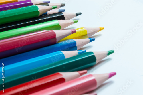 Close-Up Of Multi Colored Pencils Over White Background