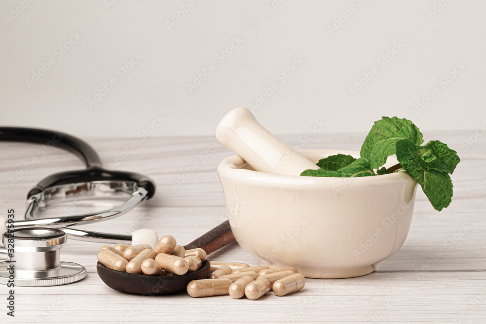 Stethoscope with medicine herbal capsule, vitamin, mineral for healthy good life. Stethoscope with medicine herbal capsule, vitamin, mineral for healthy good life.