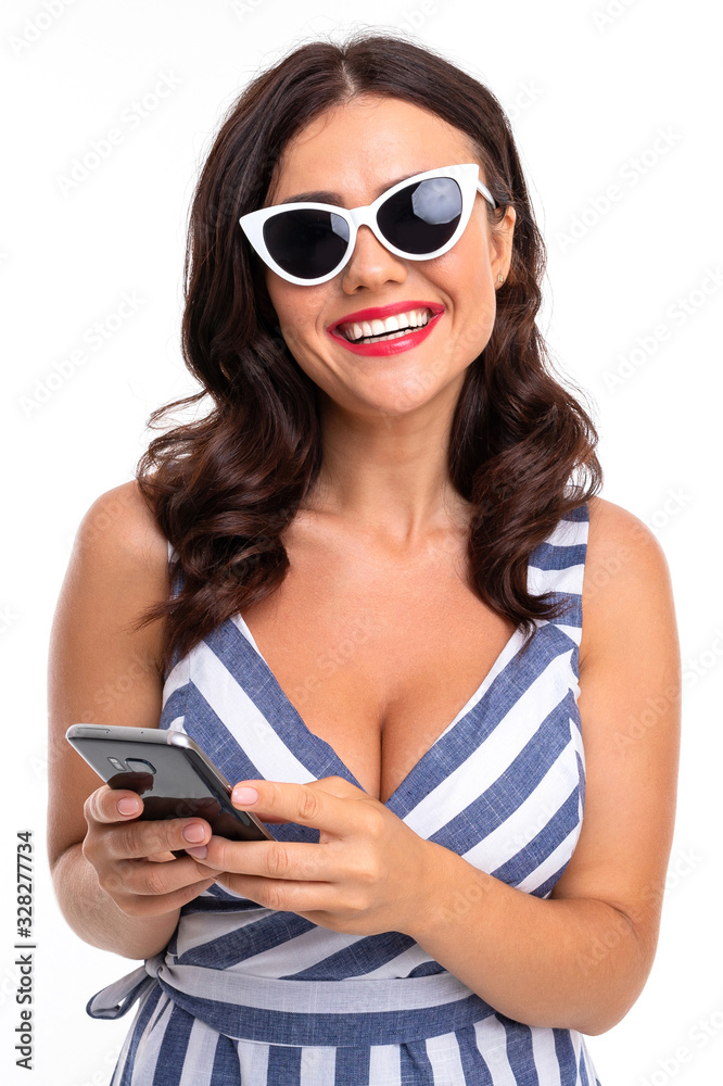 Portrait of nice caucasian girl holds a phone isolated on white background Portrait of nice caucasian girl holds a phone isolated on white background