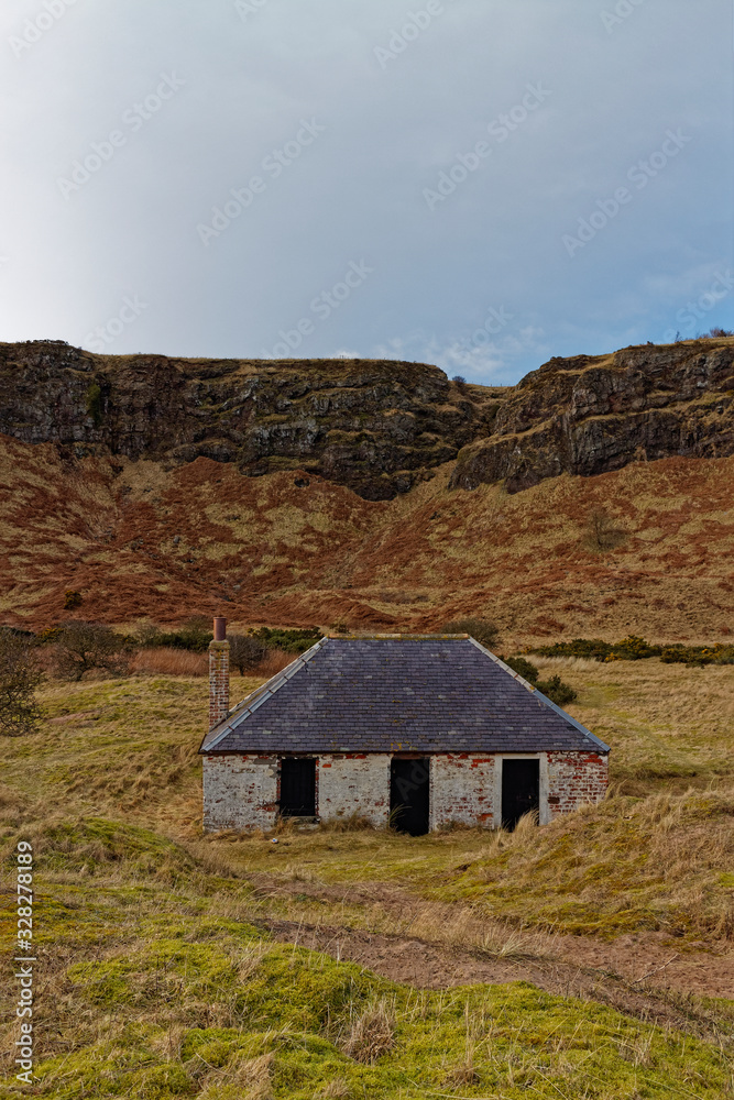 An abandoned Fishermen's Cottage set back from the beach at St Cyrus, and sheltered beneath the Volcanic Cliffs.