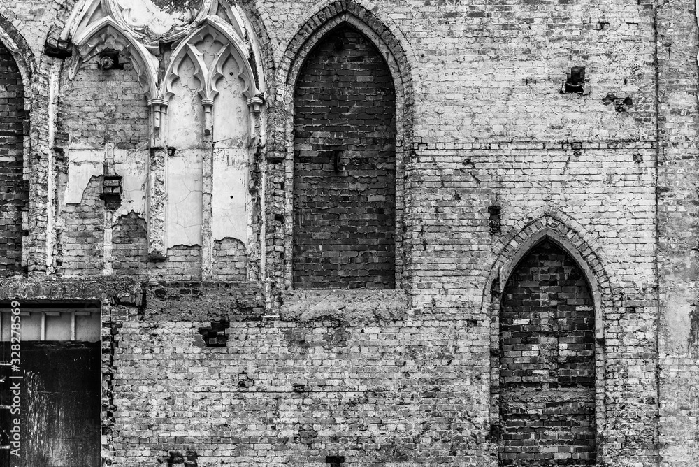 The internal white painted wall of a destroyed church with bricked up arches. The internal white painted wall of a destroyed church with bricked up arches.