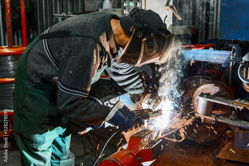 A welder is welding metal parts.