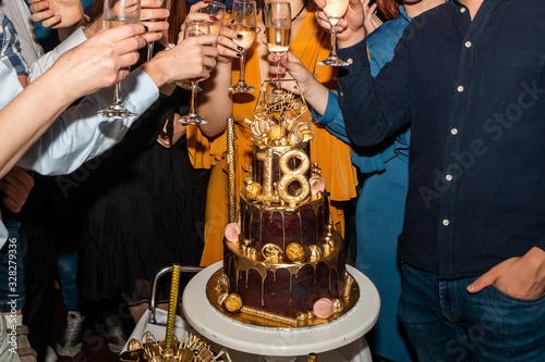 Cheers! Guests on the 18. birthday party toasting with champagne.