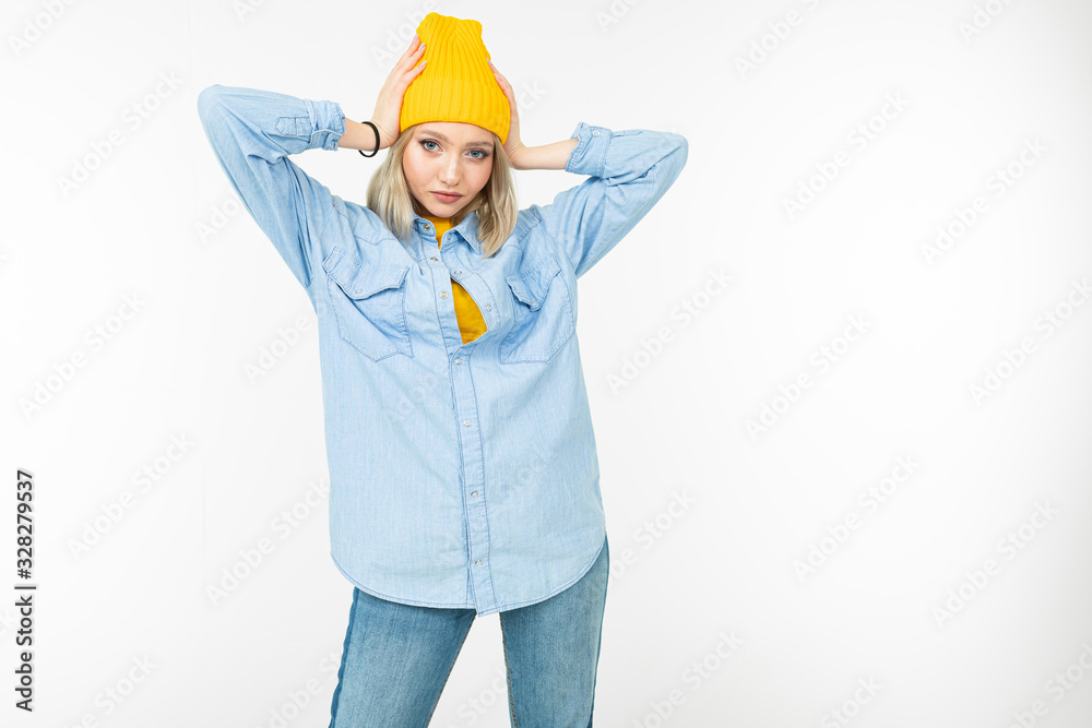 close-up of a model girl in a stylish denim shirt with a blonde haircut on a white studio background close-up of a model girl in a stylish denim shirt with a blonde haircut on a white studio background