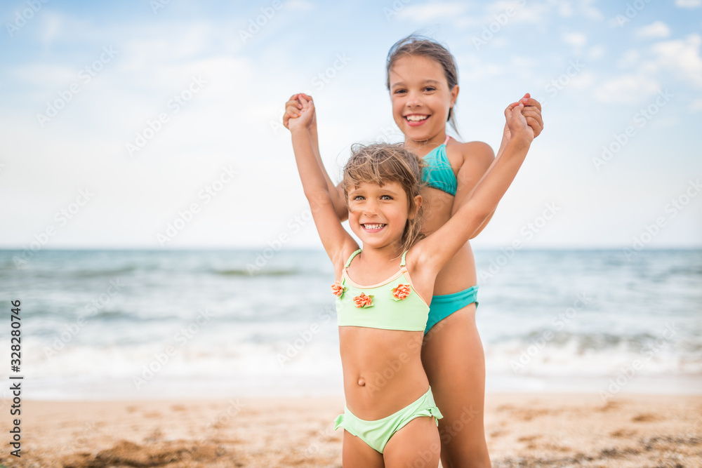 Two cute positive little girls sisters