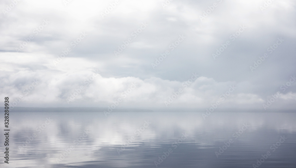Reflection of grey clouds in lake water