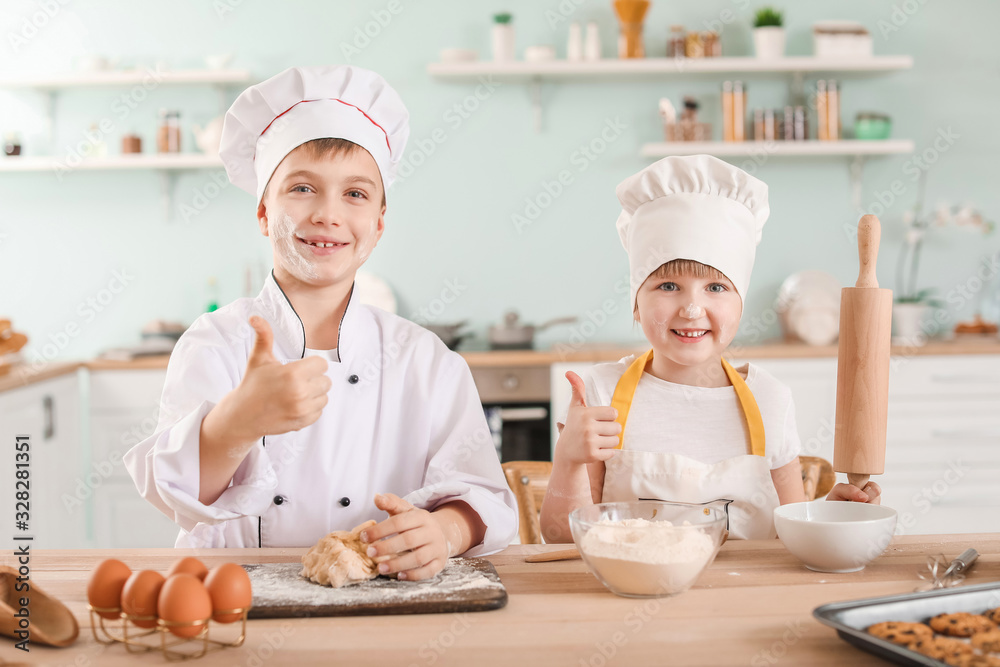 Cute little chefs cooking in kitchen Cute little chefs cooking in kitchen
