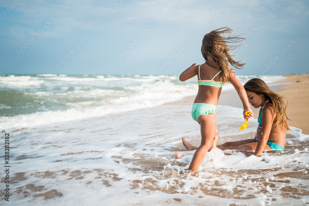 Joyful little girl enjoys a beach day