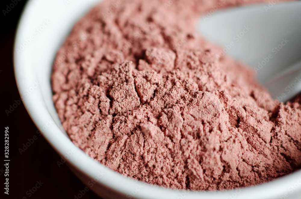 Pink bentonite clay powder in the onyx bowl. Diy facial mask and body wrap recipe. Natural beauty treatment and spa. Clay texture closeup, selective focus. Pink bentonite clay powder in the onyx bowl. Diy facial mask and body wrap recipe. Natural beauty treatment and spa. Clay texture closeup, selective focus.