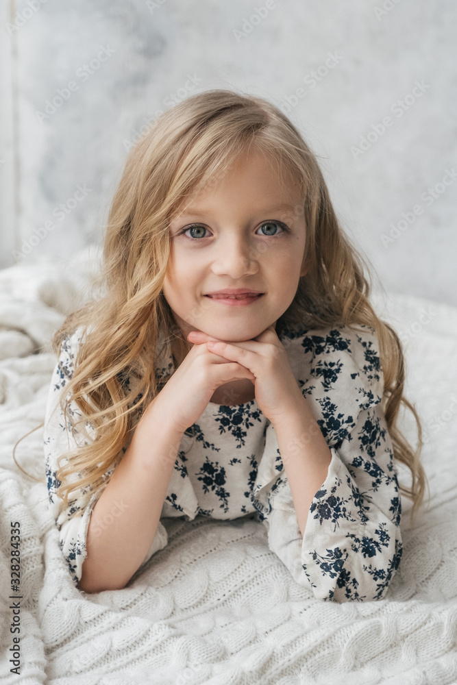 Beautiful charming girl child 7 years old. smiling, looking at the camera. Stylishly fashionably dressed in white trousers and a shirt. Beautiful charming girl child 7 years old. smiling, looking at the camera. Stylishly fashionably dressed in white trousers and a shirt.