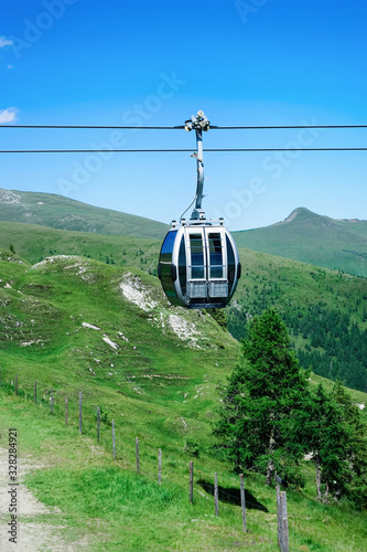 Panoramic view with cable cars in mountains and blue sky at Bad Kleinkirchheim Austria photo