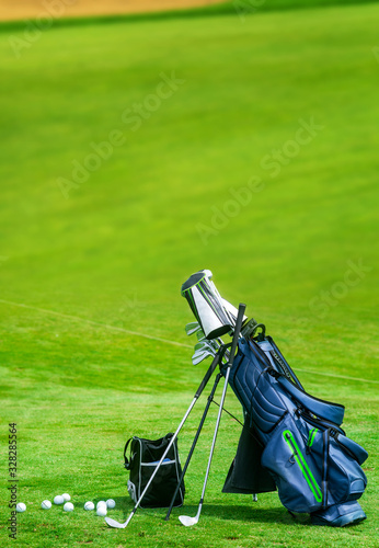 Bag of golf clubs on the golf course vertical copy space photo