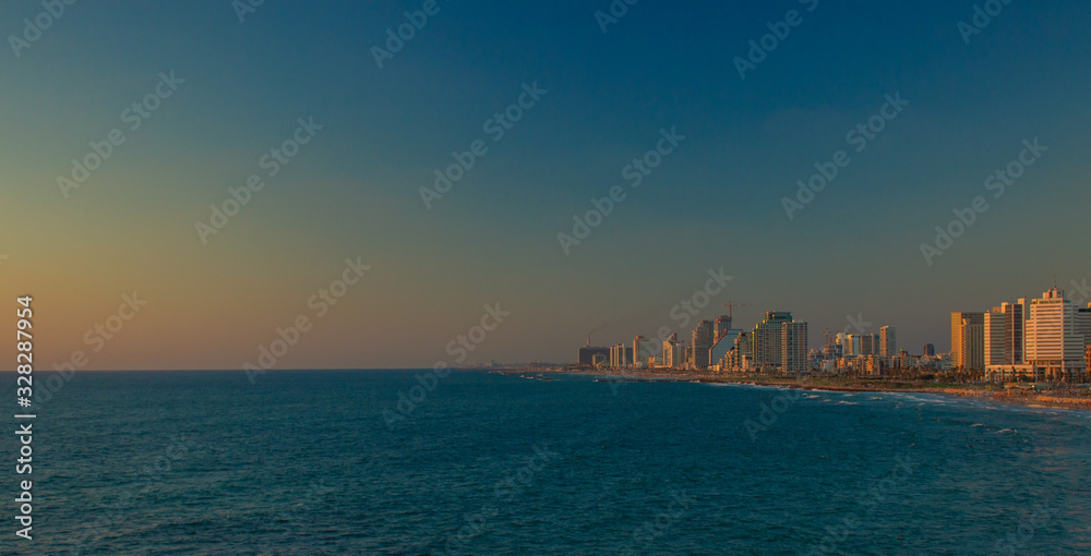 Tel Aviv capital of Israel hige beautiful city waterfront Mediterranean area landmark and landscape view skyscraper building and sea water in twilight evening sunset lighting, copy space
