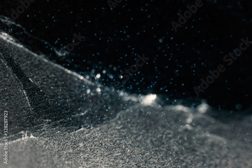 Cosmic and dust abstract background with selective focus. Creativity winter snow backdrop