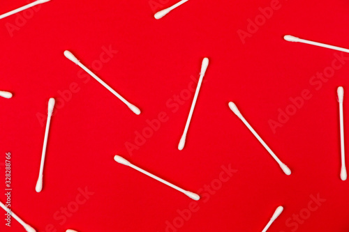 Flat lay composition with cotton swabs on red background. Top view ear sticks