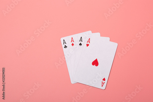 Expanded playing cards on pink background
