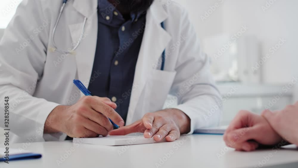 Handheld view of doctor writing a prescription. Shot with RED helium camera in 8K Handheld view of doctor writing a prescription. Shot with RED helium camera in 8K