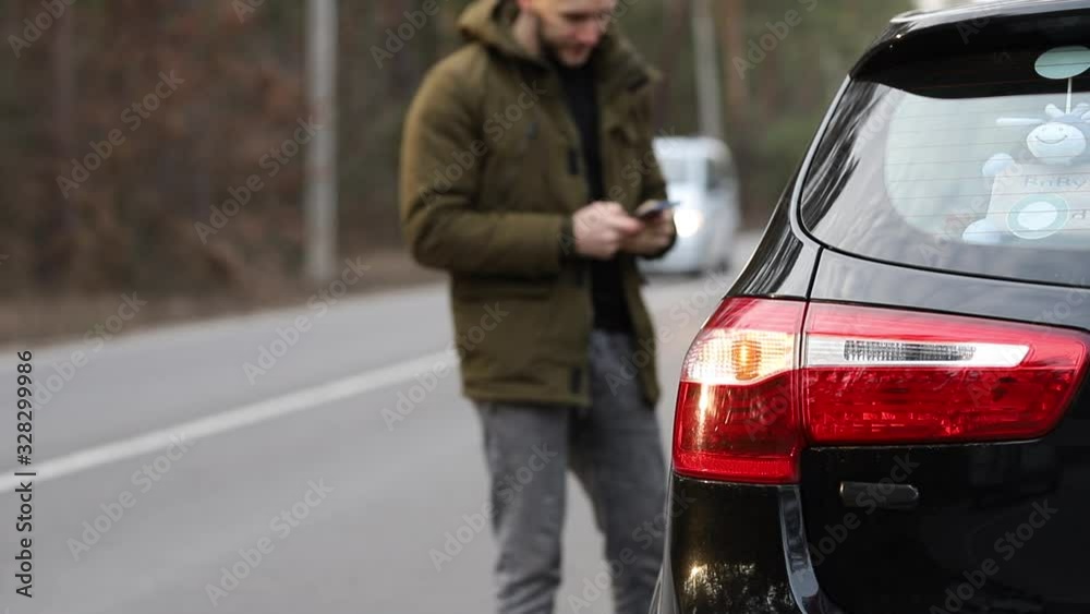 A man calls a tow truck due to a car breakdown A man calls a tow truck due to a car breakdown