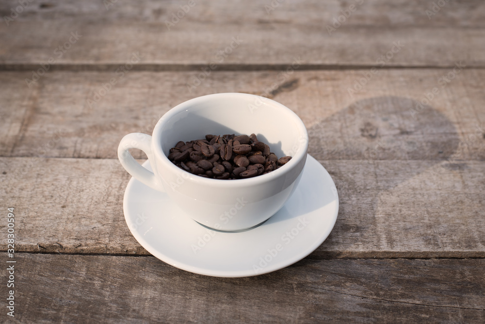 Cup of coffee beans on a wooden table Cup of coffee beans on a wooden table