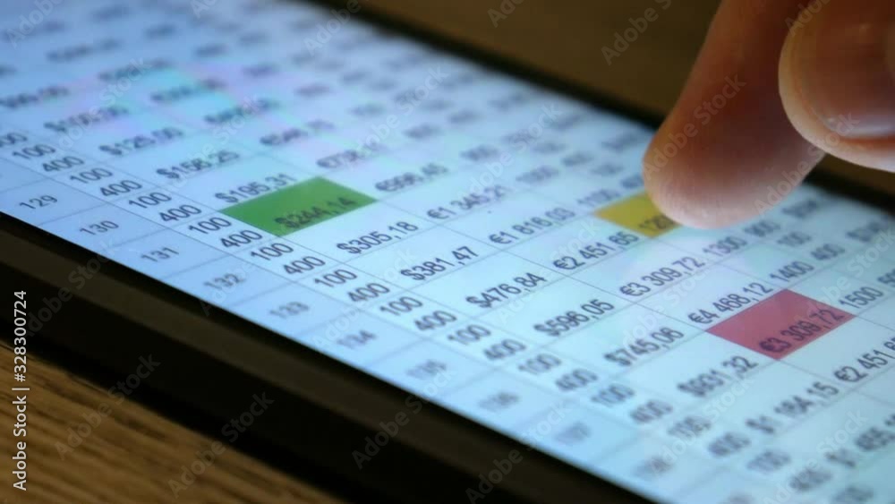 The hand (finger) work with phone touchscreen. Working with with financial, economic tables. Concept.Table, finance, currency. Close up macro view. The hand (finger) work with phone touchscreen. Working with with financial, economic tables. Concept.Table, finance, currency. Close up macro view.