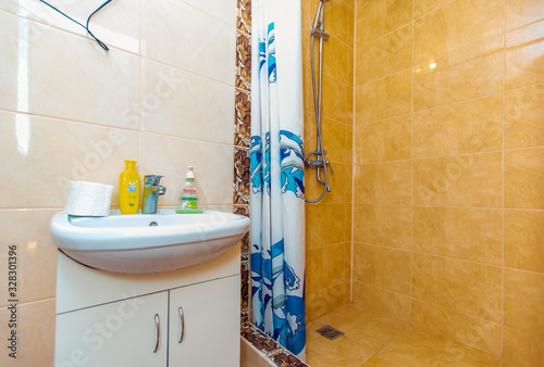 Bathroom in the guest house in light yellow tiles