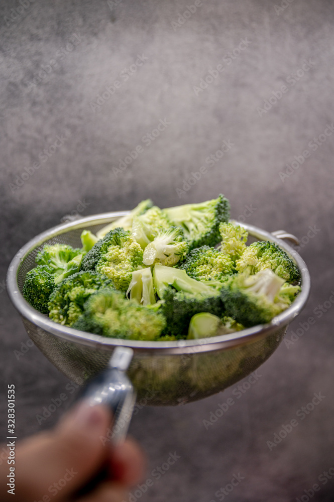 Green fresh brocolli in a colander. Green fresh brocolli in a colander.