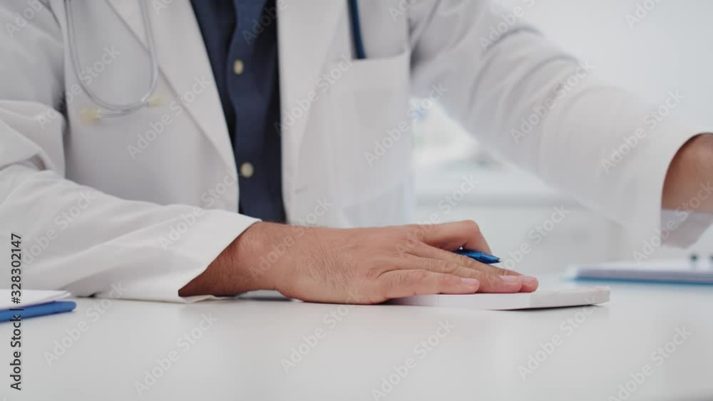 Handheld video shows of doctor writing prescription and taking a bribe. Shot with RED helium camera in 8K Handheld video shows of doctor writing prescription and taking a bribe. Shot with RED helium camera in 8K