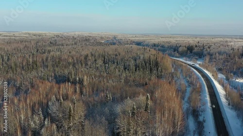 Aerial video view of winter road in taiga on Salair Ridge in winter photo