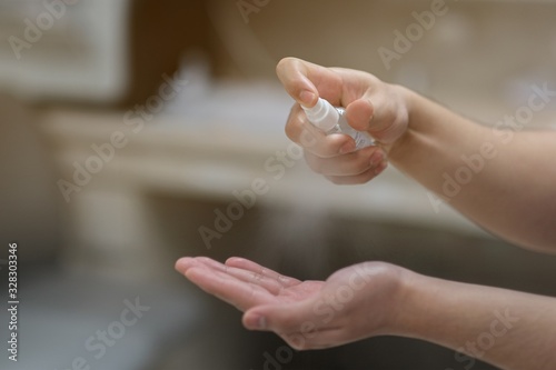 A man using alcohol spray for cleaning hands