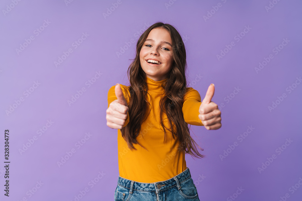 Image of young beautiful woman smiling and gesturing thumbs up Image of young beautiful woman smiling and gesturing thumbs up