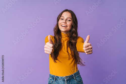 Image of young beautiful woman smiling and gesturing thumbs up