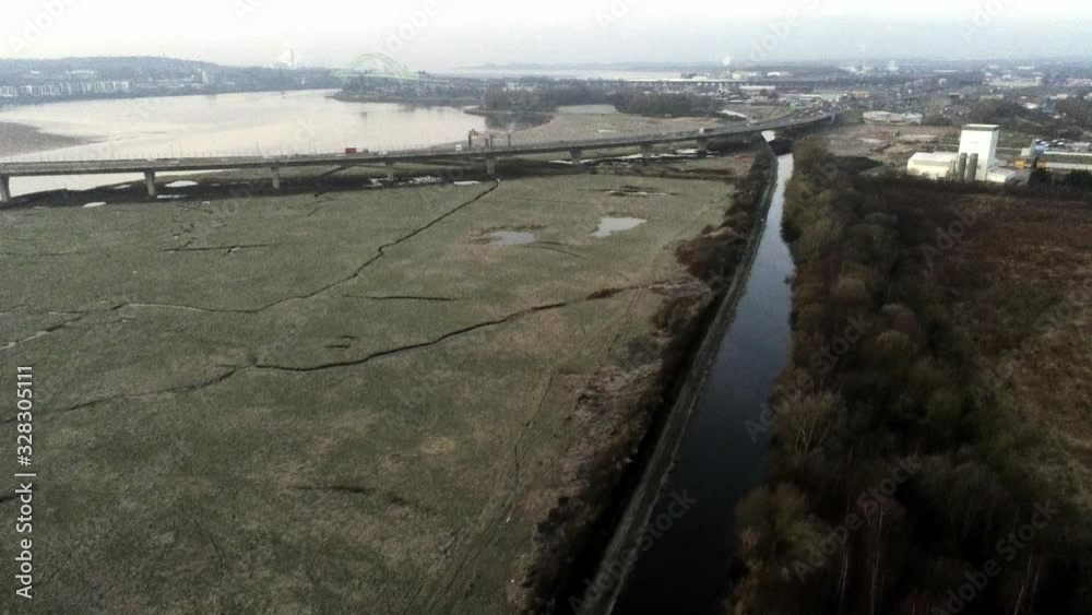 custom made wallpaper toronto digitalAerial pull back across river marsh land coast commuter traffic crossing bridge uk