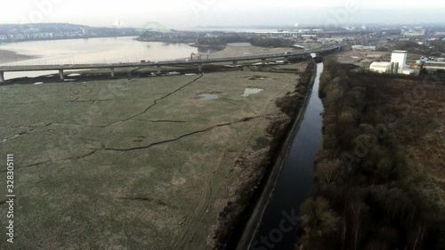 Wallpaper Mural Aerial pull back across river marsh land coast commuter traffic crossing bridge uk Torontodigital.ca