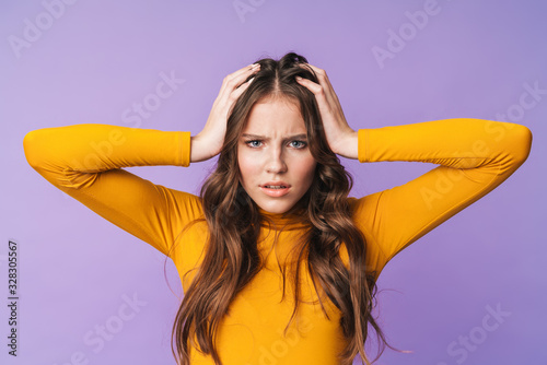 Photography Image of young displeased woman being nervous and grabbing her head