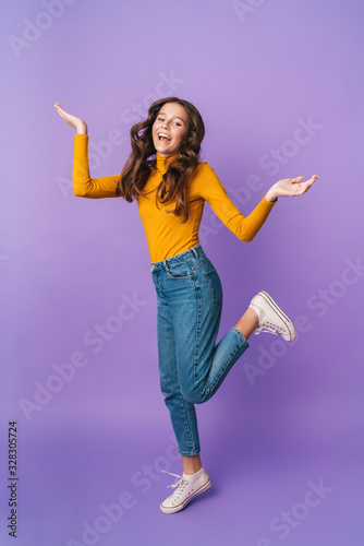 Full length image of young beautiful woman smiling and throwing up arms
