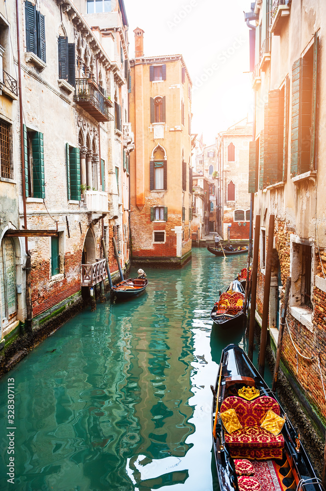 Scenic canal with gondolas in Venice, Italy. Famous travel destination