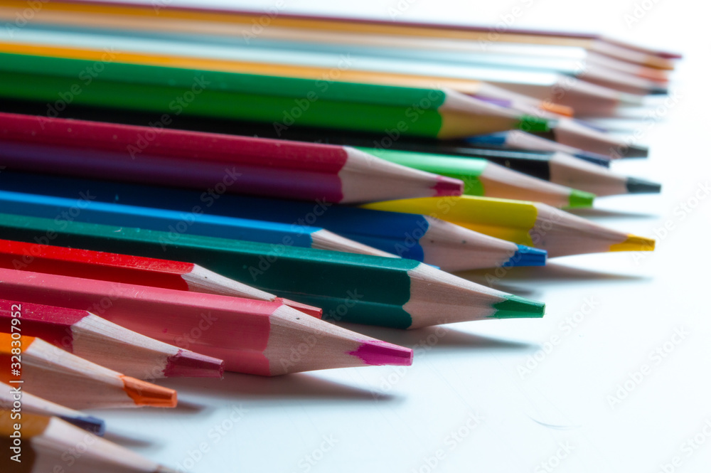 Close-Up Of Multi Colored Pencils Over White Background