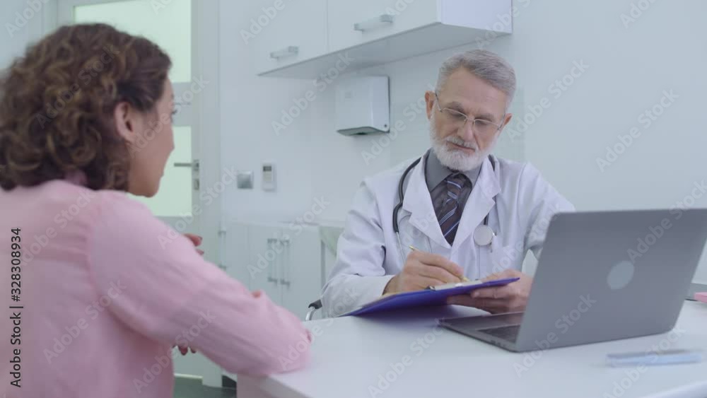 Female patient describing illness symptoms to doctor, receiving medical services Female patient describing illness symptoms to doctor, receiving medical services