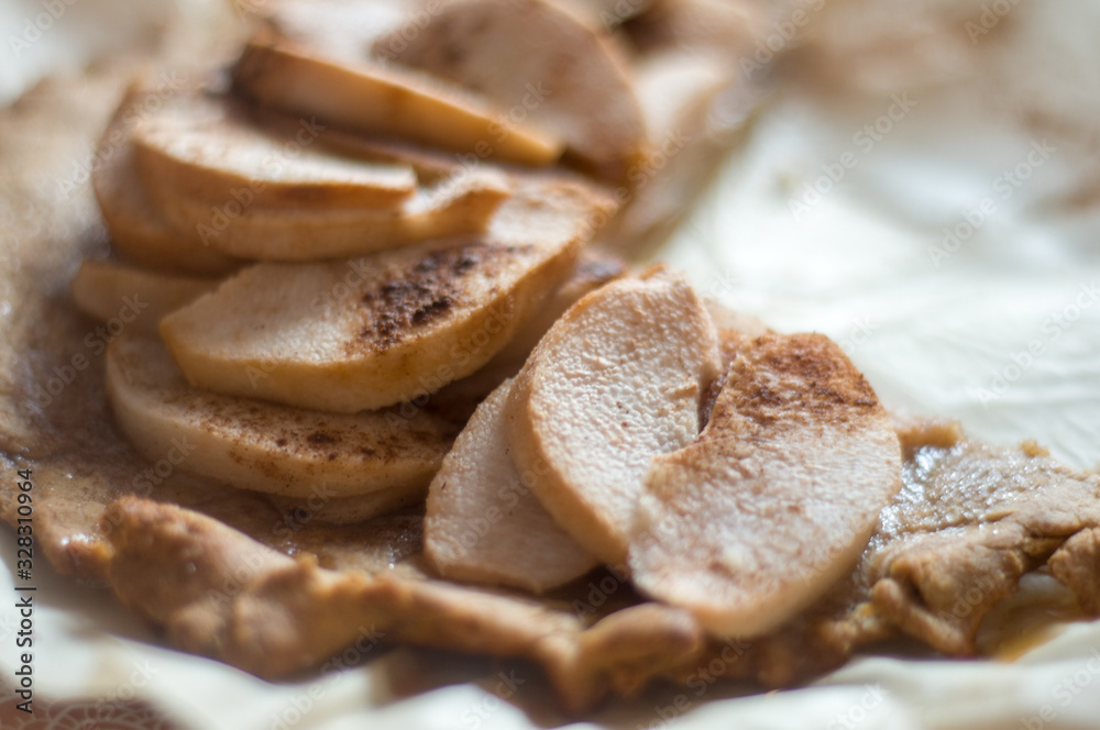 Apple slices in focus. Apple pie in blur. Food background Apple slices in focus. Apple pie in blur. Food background