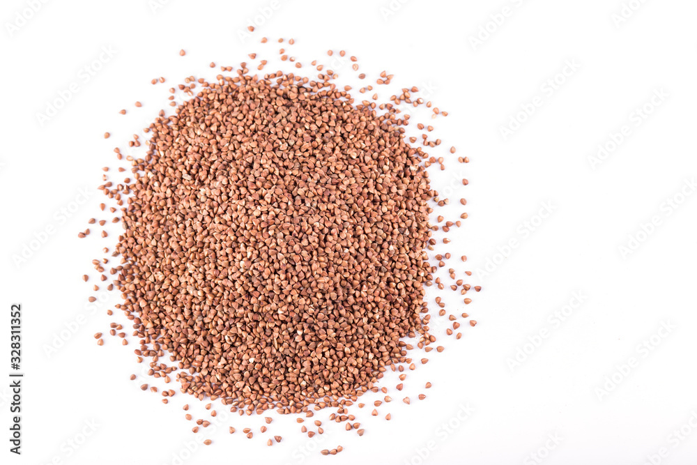heap of buckwheat scattered on a white background heap of buckwheat scattered on a white background
