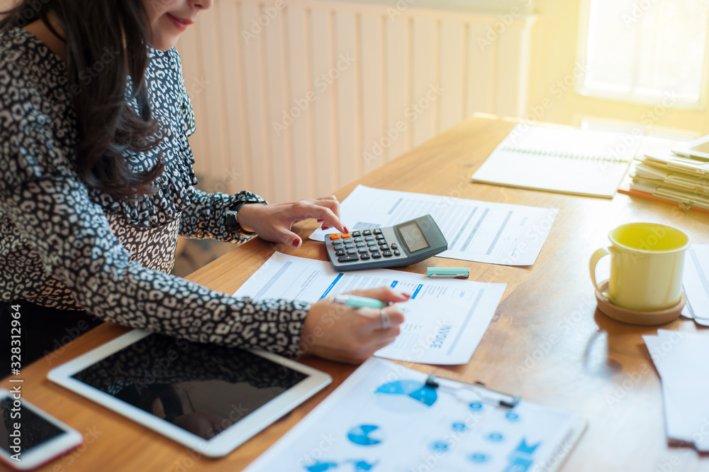Women are calculating about her expenses and liabilities. Women are calculating about her expenses and liabilities.