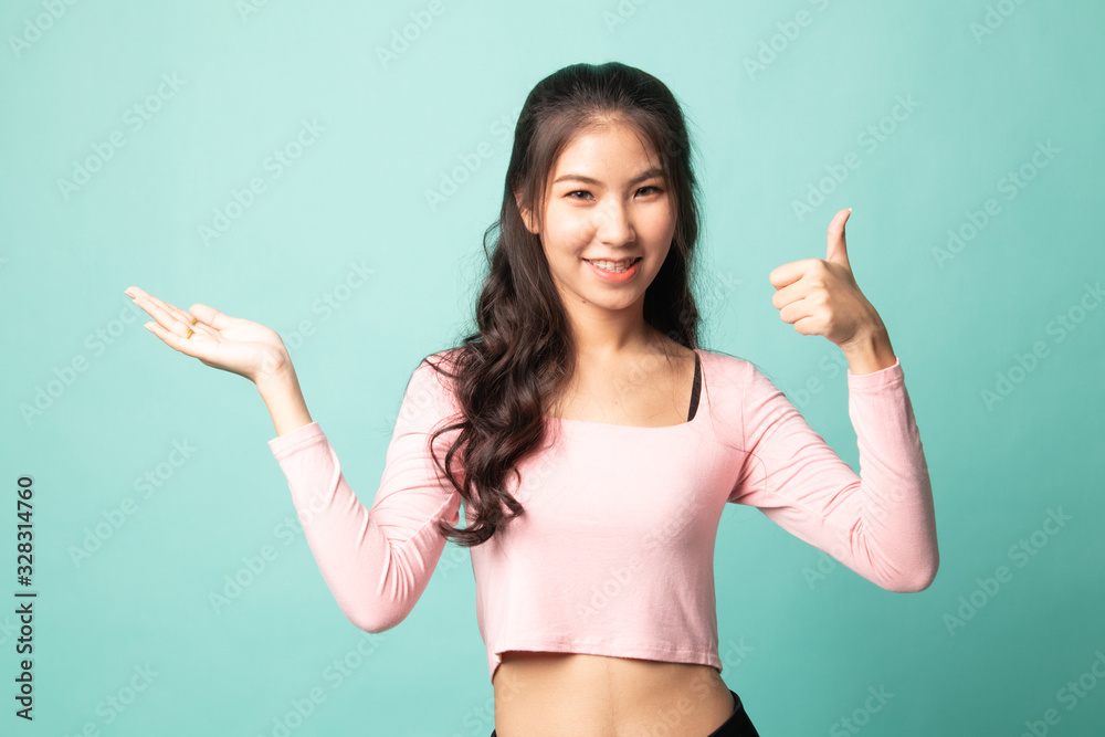 Beautiful young Asian woman show palm hand and thumbs up. Beautiful young Asian woman show palm hand and thumbs up.