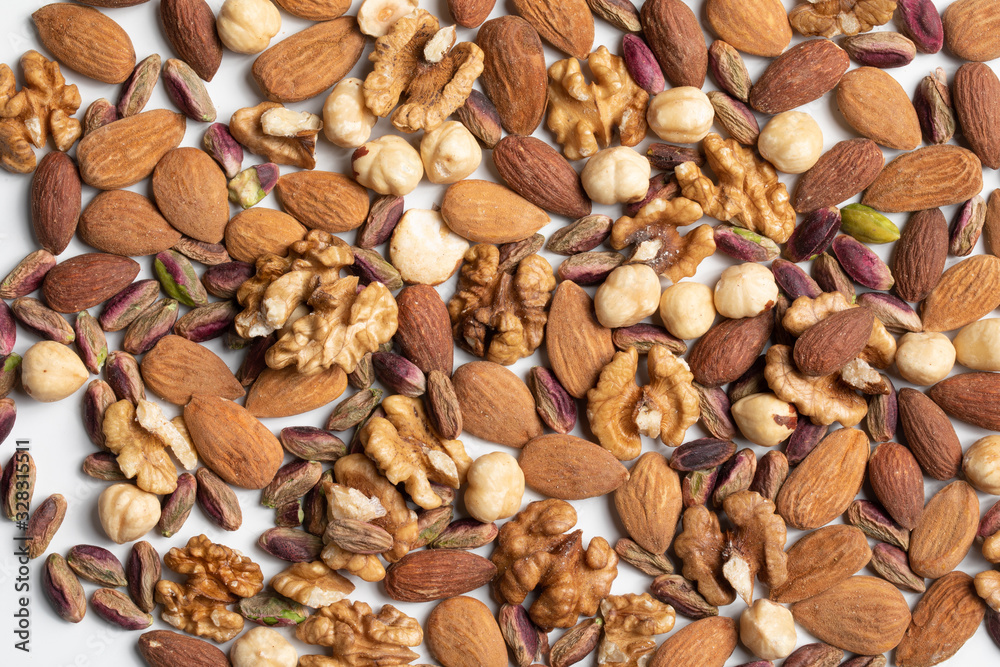 Shelled raw mix dry fruits texture in white background Shelled raw mix dry fruits texture in white background