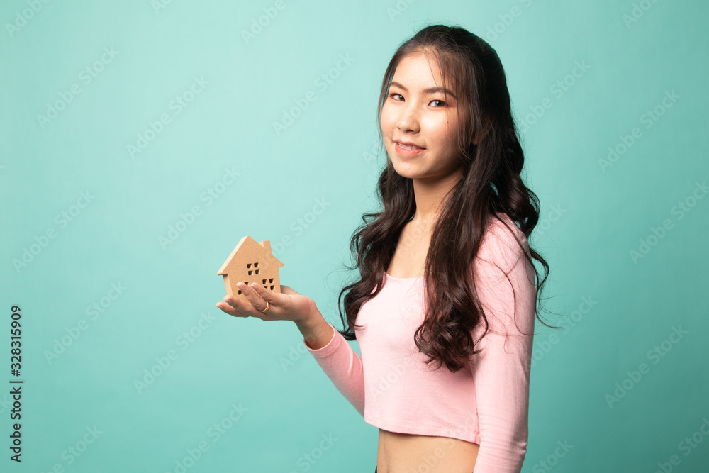 Happy young asian woman with house model. Happy young asian woman with house model.