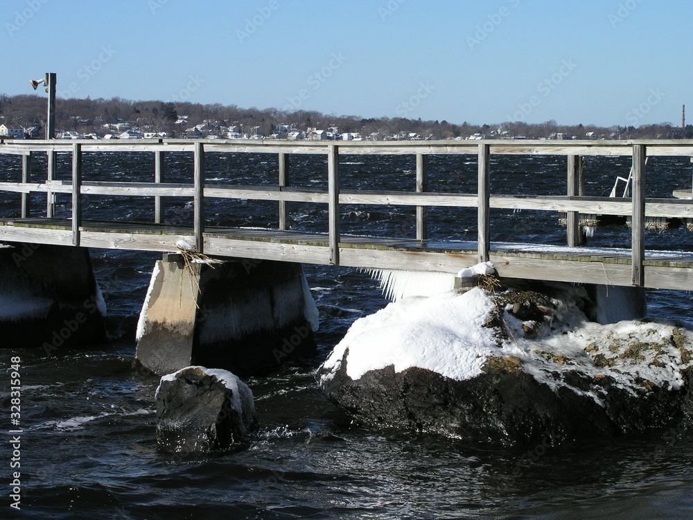 Dock on river with ice and snow