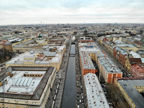 Aerial view of Griboyedov Canal and Kazan Cathedral with high traffic at winter. different roofs of citycenter of Saint-Petersburg cityscape 